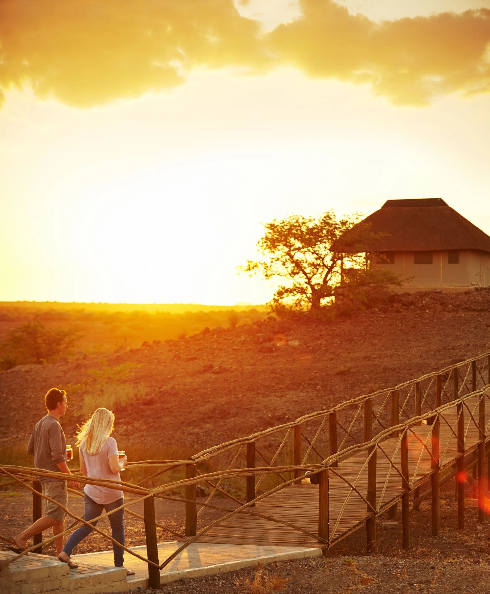 Luxury safari camp with lanterns glowing at dusk