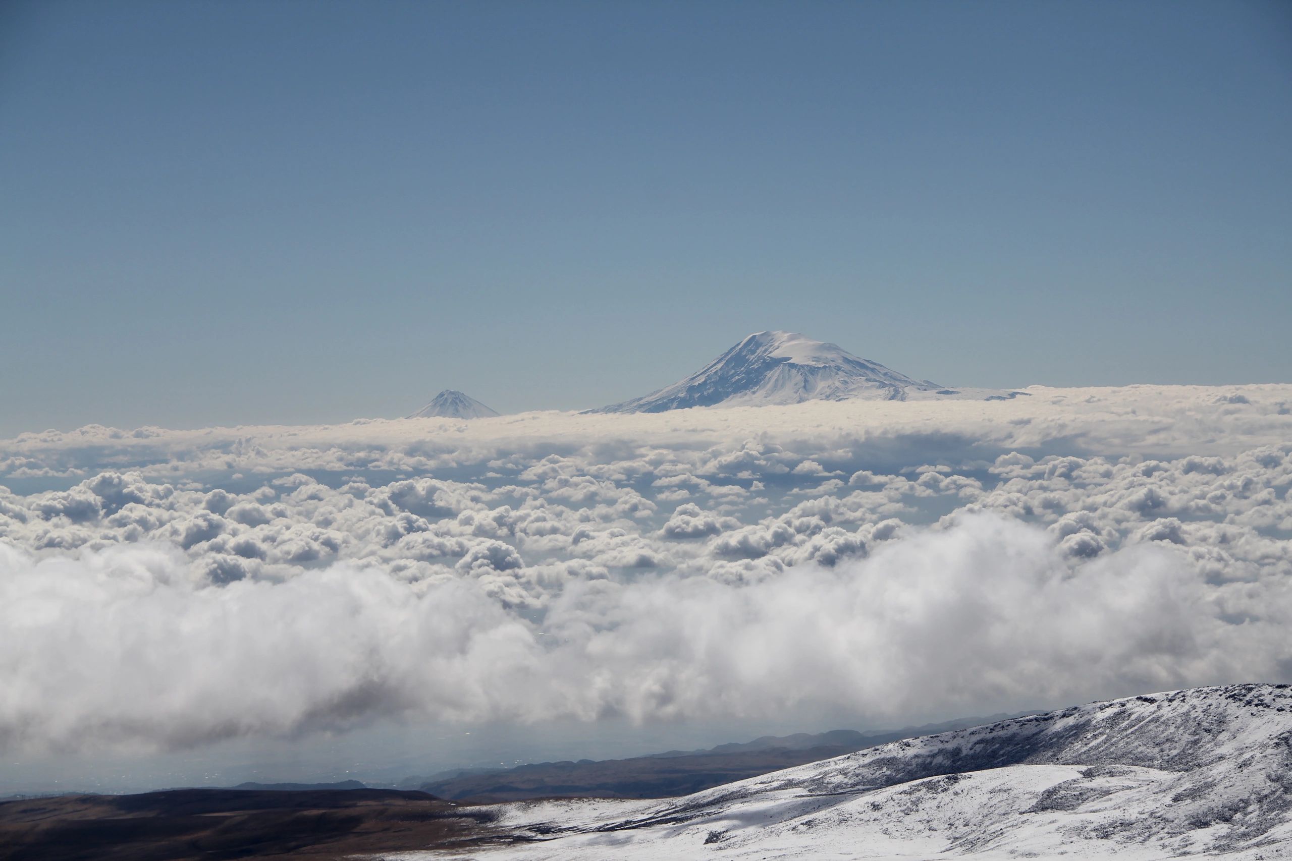 Aerial view of Mount Kilimanjaro snow-capped summit above the clouds